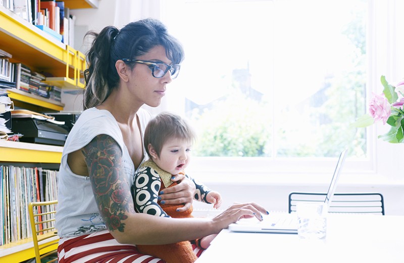 Mother and daughter sitting in front of a laptop