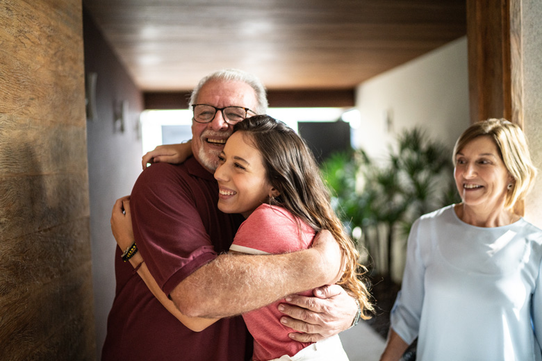Happy family embracing at home